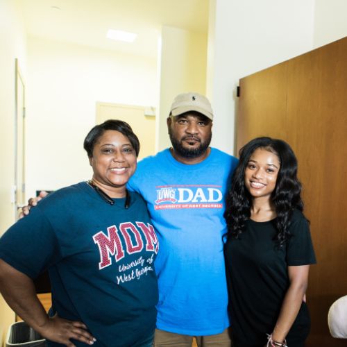 Student with parents in dorm room
